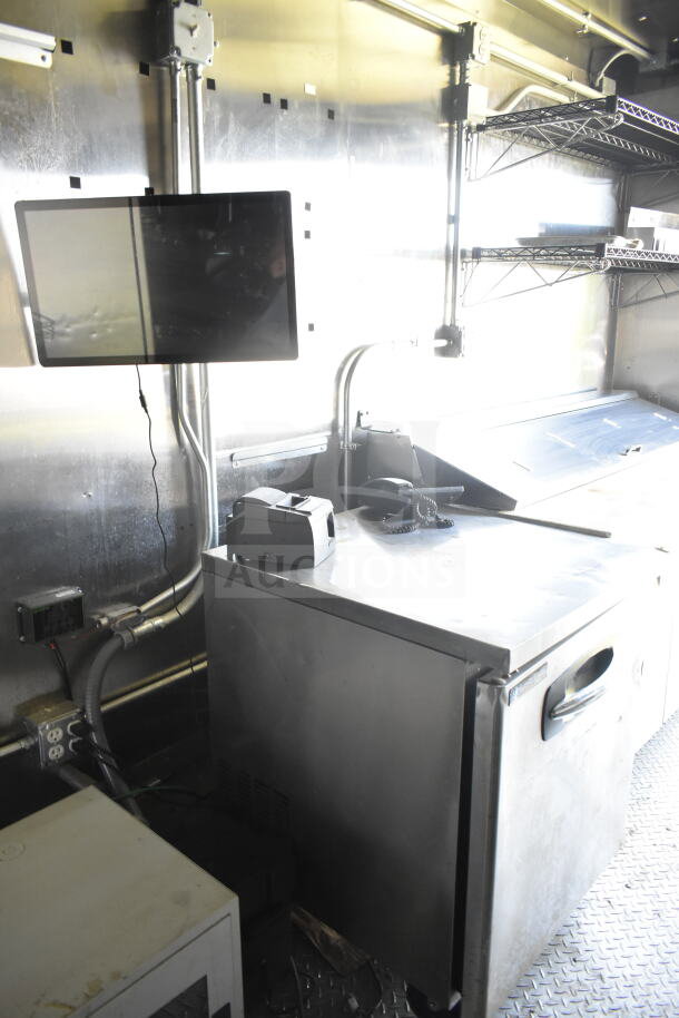 2021 Diamond Cargo 8.5'x24' food trailer interior with appliances, including CaptiveAire grease hood and refrigeration unit.