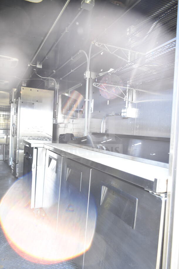 2021 Diamond Cargo 8.5'x24' food trailer interior with CaptiveAire grease hood, Turbochef ovens, and refrigeration unit.