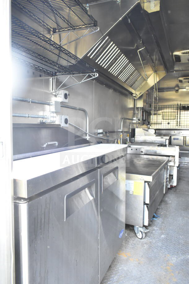 2021 Diamond Cargo 8.5'x24' food trailer interior with CaptiveAire grease hood, commercial ovens, and refrigeration units.