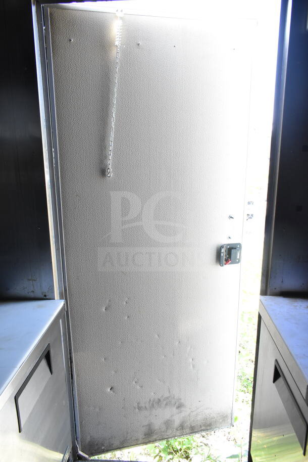 2021 Diamond Cargo 8.5'x24' food trailer interior view; shows door with chain, stainless steel storage on sides.