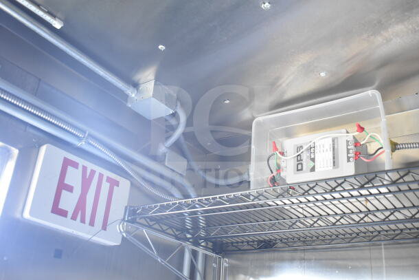 Interior of 2021 Diamond Cargo food trailer, showing electrical wiring, EXIT sign, and DPS electrical component on metal shelf.