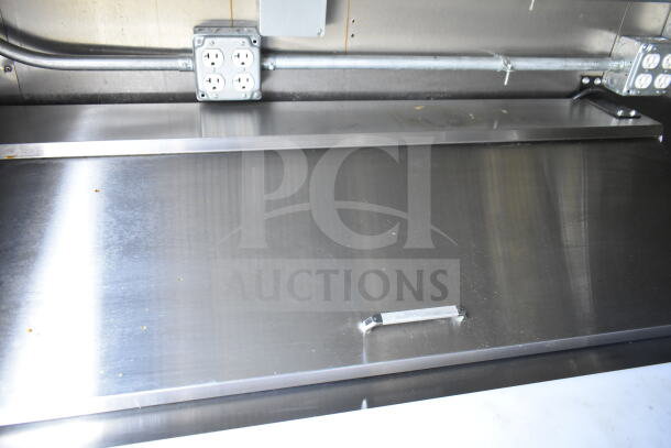 2021 Diamond Cargo 8.5'x24' food trailer interior with stainless steel countertop, electrical outlets, part of CaptiveAire system.