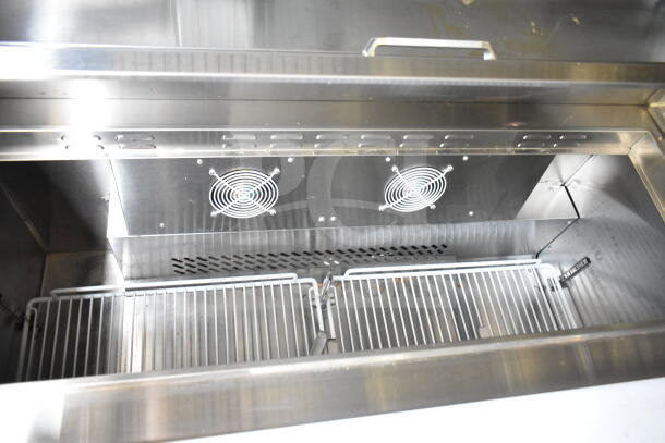 Interior of a 2021 Diamond Cargo food trailer showing refrigeration unit with wire racks and dual cooling fans.