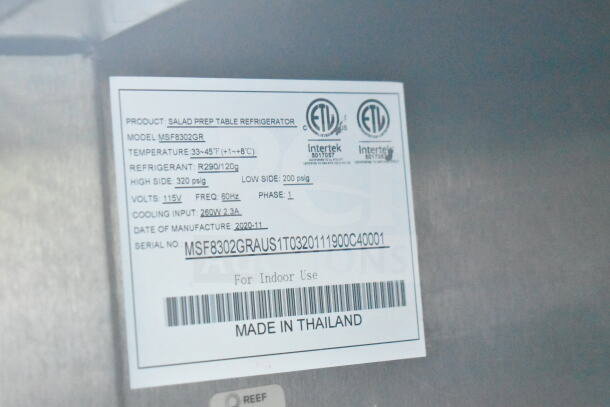 Label on salad prep table refrigerator, model MSF8302GR, specifies refrigerant R290 and temperature range 33-45°F. Made in 2020.