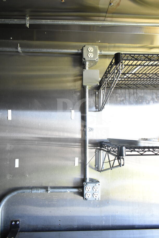 2021 Diamond Cargo 8.5'x24' food trailer interior; visible electrical outlets and metal shelving, clean condition.