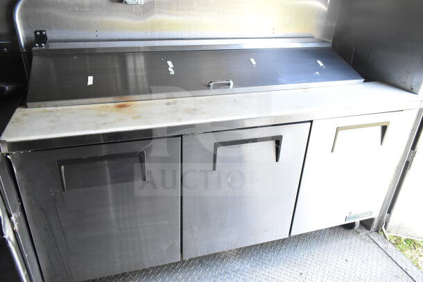 2021 Diamond Cargo food trailer interior with stainless steel counters and refrigeration. Slight wear visible.