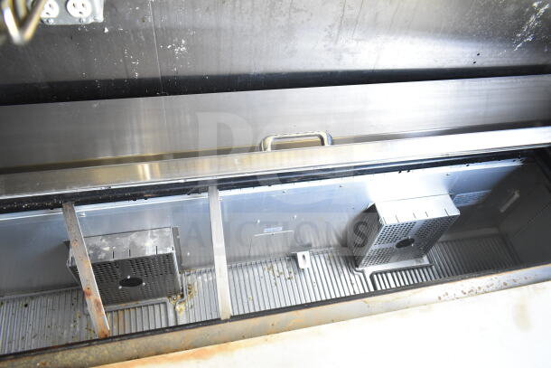 Interior view of 2021 Diamond Cargo 8.5'x24' food trailer showing stainless steel Countertop and refrigeration unit.