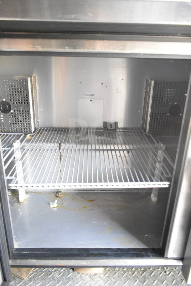 Interior of a 2021 Diamond Cargo food trailer showing shelving inside a refrigeration unit. Visible grime and wear.