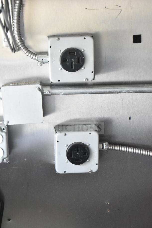 Electrical outlets and conduit inside 2021 Diamond Cargo 8.5'x24' food trailer. Sturdy metal construction, clean condition.