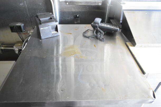 2021 Diamond Cargo 8.5'x24' food trailer interior with stainless steel counter, printer, and phone. Features grease hood, ovens.