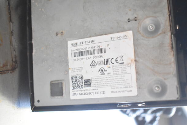 Label on a Star Micronics TSP100 model device showing model number, electrical specs, and QR code for manual.