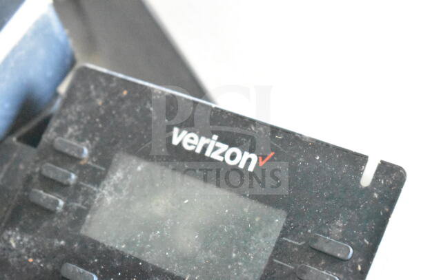 Verizon device close-up, showing brand logo on a dusty black surface.