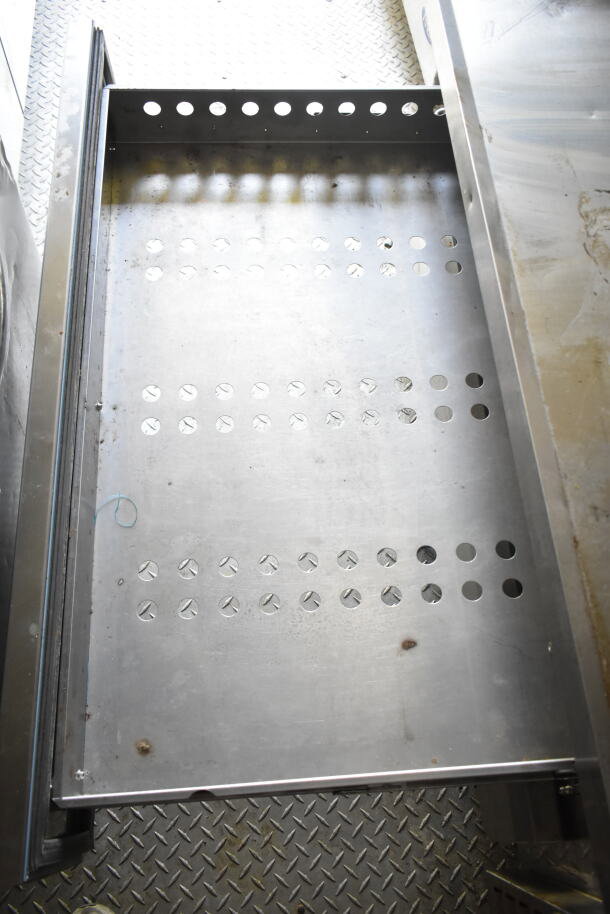 Metal shelf inside a 2021 Diamond Cargo food trailer, featuring perforated design, in good condition.