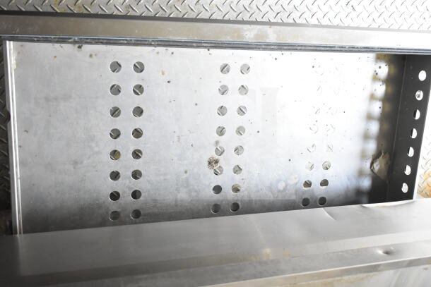 2021 Diamond Cargo food trailer interior featuring CaptiveAire grease hood. Stainless steel surfaces and ventilation details visible.