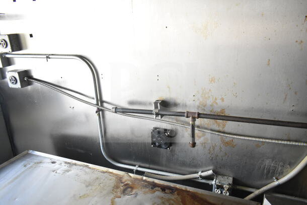 Interior view of 2021 Diamond Cargo food trailer showing Electrics and piping in used condition. Visible wear on surfaces.