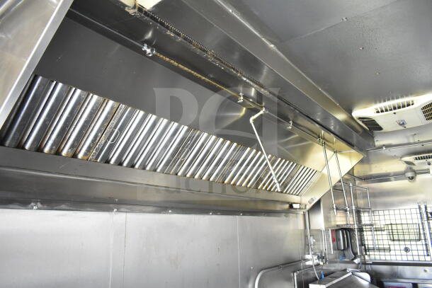 2021 Diamond Cargo 8.5'x24' food trailer interior with CaptiveAire grease hood, stainless steel finish, and ceiling vents.