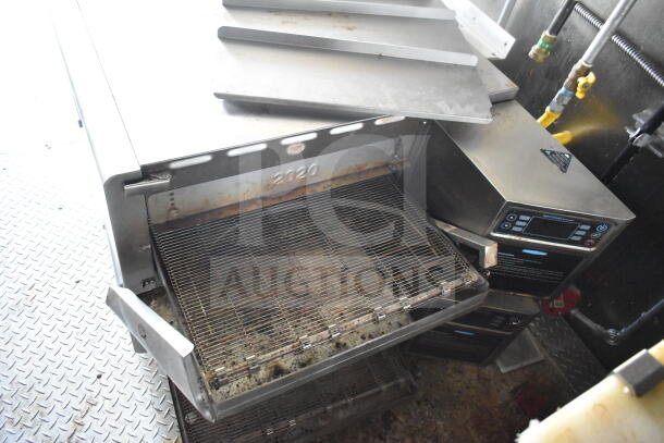 2021 Diamond Cargo food trailer interior featuring CaptiveAire grease hood and Turbochef rapid cook ovens. Visible grill racks.