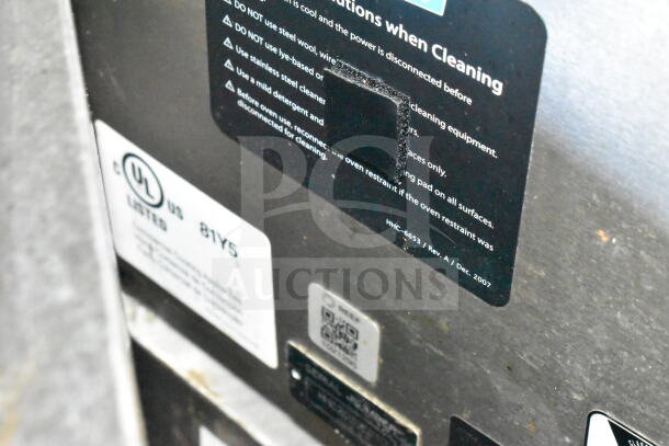 Description labels on the interior machinery of a 2021 Diamond Cargo 8.5'x24' food trailer, featuring cleaning instructions and UL certification.