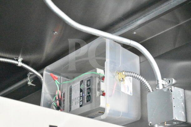 Electrical wiring and digital phase shifter inside a 2021 Diamond Cargo food trailer. Visible cables and components.