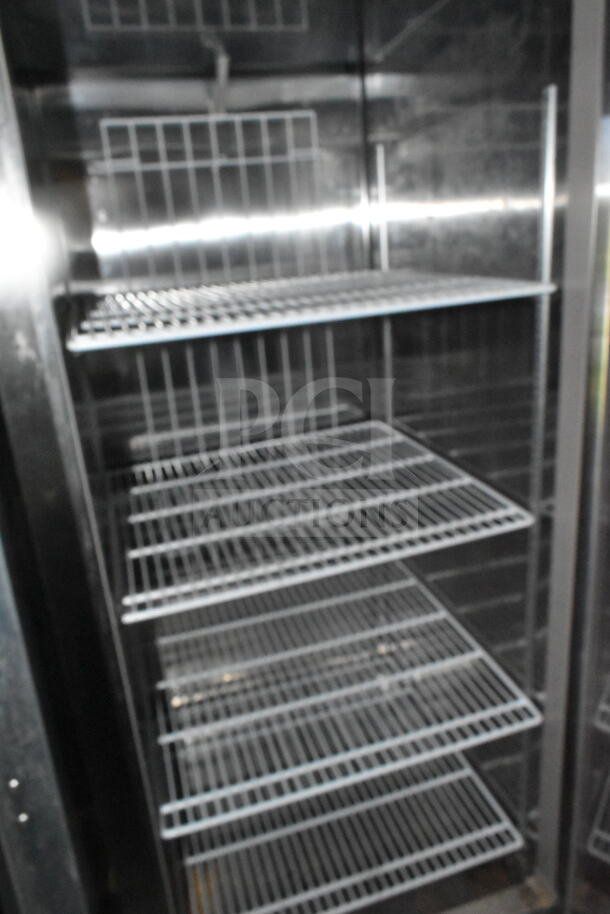 Empty interior of a commercial refrigerator with multiple wire shelves inside a 2021 Diamond Cargo food trailer.
