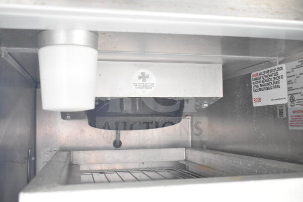 Interior view of refrigeration unit in 2021 Diamond Cargo food trailer, showing fan and safety labels.
