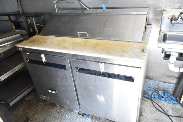 2021 Diamond Cargo 8.5'x24' food trailer interior with stainless steel prep table, CaptiveAire grease hood, visible wear.
