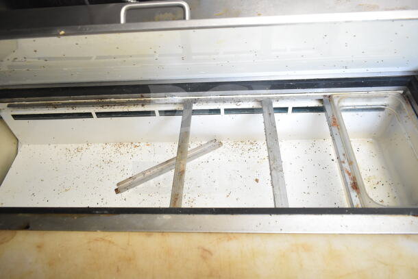2021 Diamond Cargo food trailer interior with grease hood, visible shelving, and minor dirt; VIN 53NBE2429M1089847.