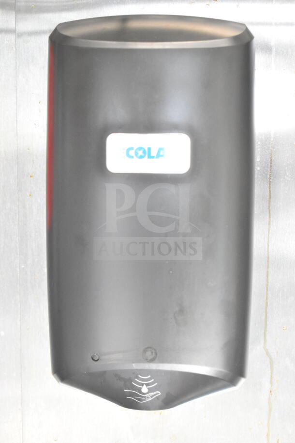 Hand sanitizer dispenser mounted on a metal wall, labeled "ECOLAB." Black with a sensor and drip icon for touchless use.