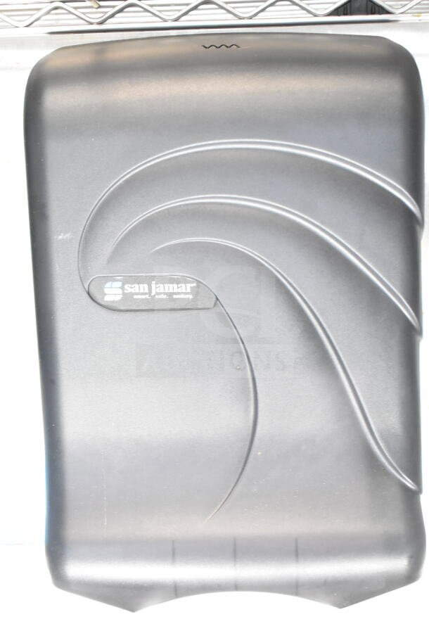 San Jamar paper towel dispenser, black, wall-mounted, sleek design, labeled with "smart. safe. sanitary."