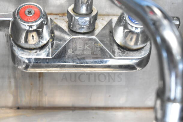 Stainless steel faucet in 2021 Diamond Cargo food trailer, labeled "BK Resources," showing wear and stains on the surface.