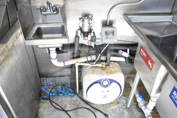 2021 Diamond Cargo 8.5'x24' food trailer interior, showing a sink with plumbing, water heater, and metal surfaces.