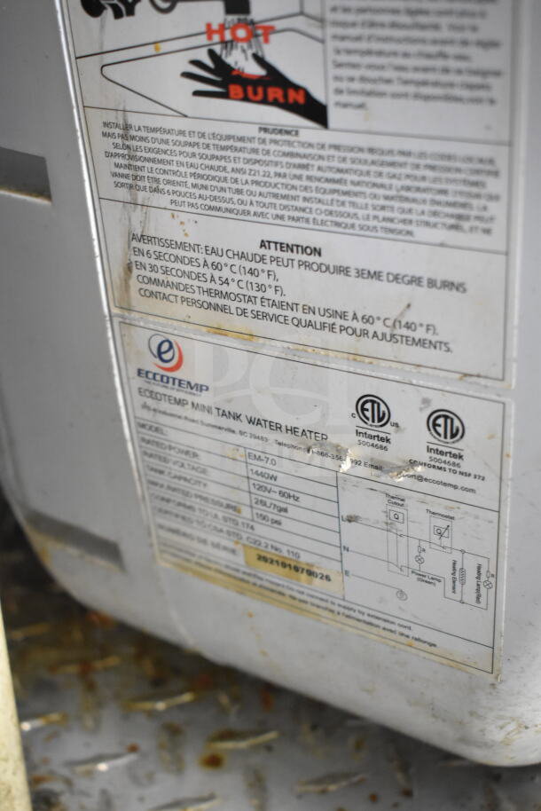 Eccotemp mini tank water heater label on a 2021 Diamond Cargo food trailer; model EM-7.0, power 1440W, 26L capacity.