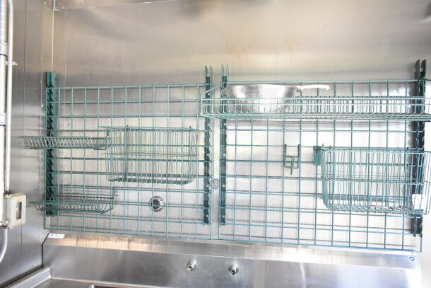 Interior of a 2021 Diamond Cargo food trailer with metal storage racks. Stainless steel surfaces and secure shelving system.