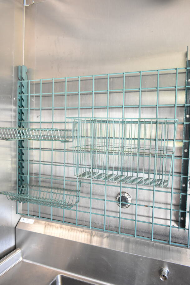 2021 Diamond Cargo 8.5'x24' food trailer interior with wire racks and stainless steel sink, featuring a Grease Hood.