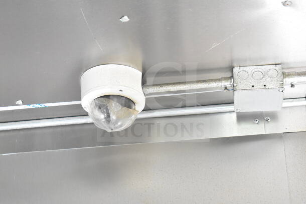 Ceiling-mounted security camera in 2021 Diamond Cargo food trailer. Visible wiring and junction box.