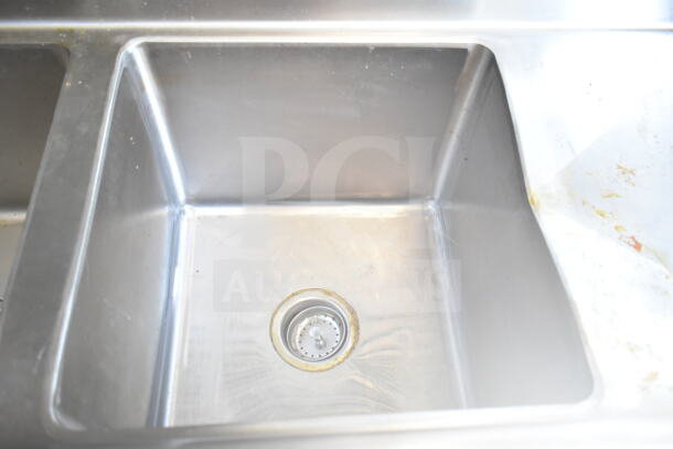 Stainless steel sink inside 2021 Diamond Cargo food trailer, visible wear, part of included kitchen equipment.