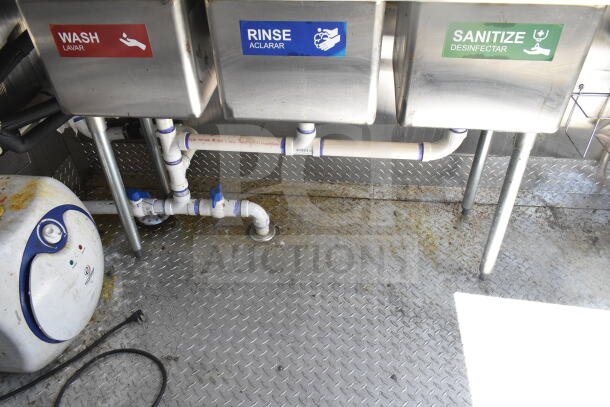 2021 Diamond Cargo 8.5'x24' food trailer sink area with "Wash," "Rinse," and "Sanitize" labels. Diamond plate flooring.