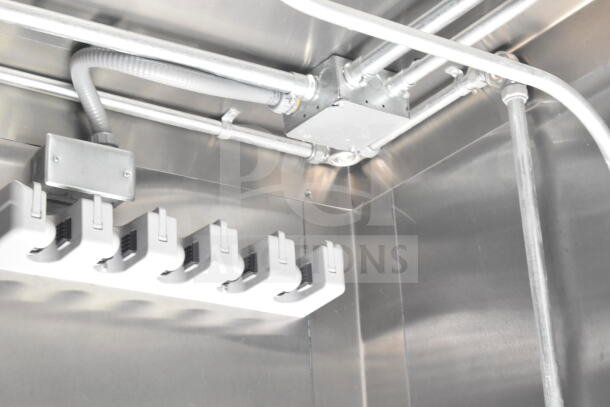 Interior view of 2021 Diamond Cargo food trailer with visible wiring and junction box. Stainless steel surfaces, new condition.