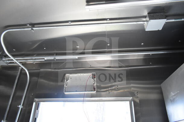 Interior of 2021 Diamond Cargo food trailer featuring stainless steel walls and electrical wiring.
