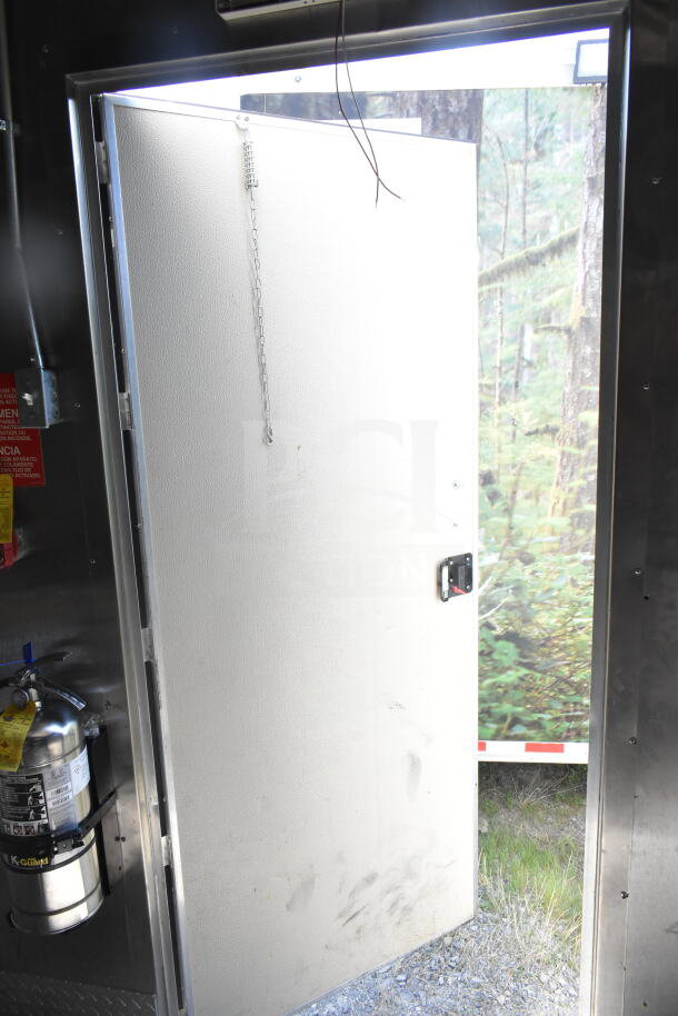 2021 Diamond Cargo 8.5'x24' food trailer door open, showing interior safety equipment and exterior view. Good condition.