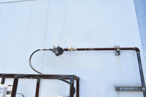 Exterior view of 2021 Diamond Cargo 8.5'x24' food trailer, showing utility connections. Featuring CaptiveAire grease hood.