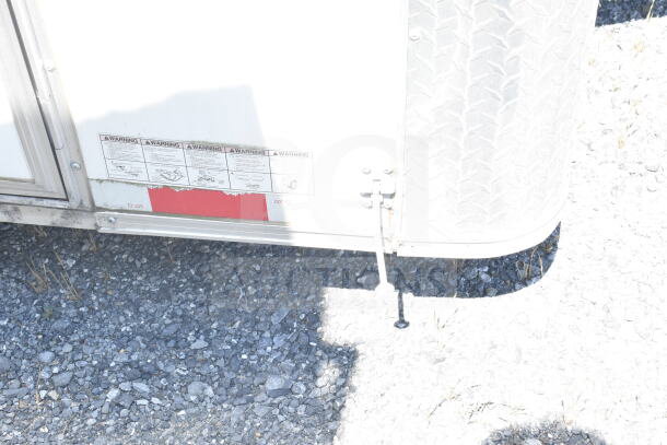 2021 Diamond Cargo 8.5'x24' food trailer side view; includes safety warning decals, visible lower side panel, and leveling support.