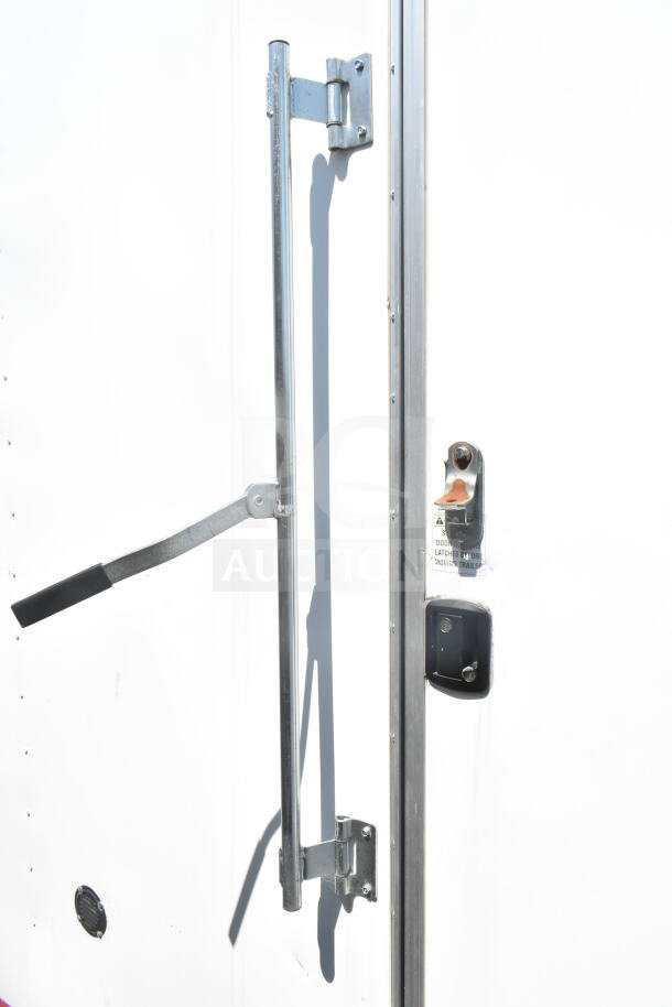 2021 Diamond Cargo 8.5'x24' food trailer door with sturdy latch and lock mechanism, in excellent condition.