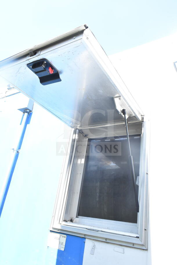 2021 Diamond Cargo 8.5'x24' food trailer, CaptiveAire grease hood. Open service window, blue and white exterior, good condition.