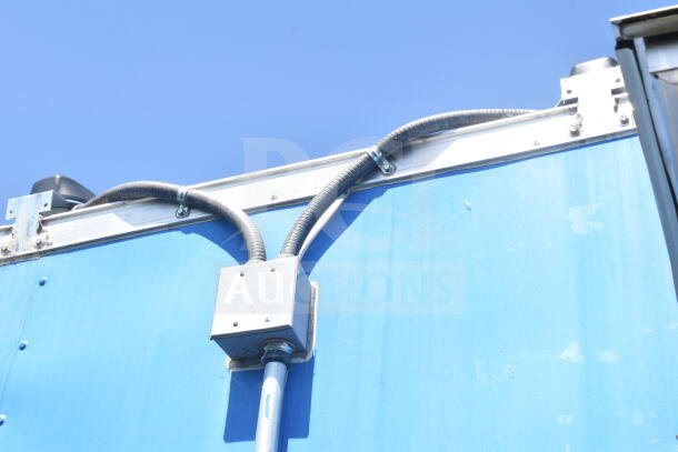2021 Diamond Cargo 8.5'x24' food trailer section, showcasing exterior wiring, in good condition. Blue finish, secure fittings.