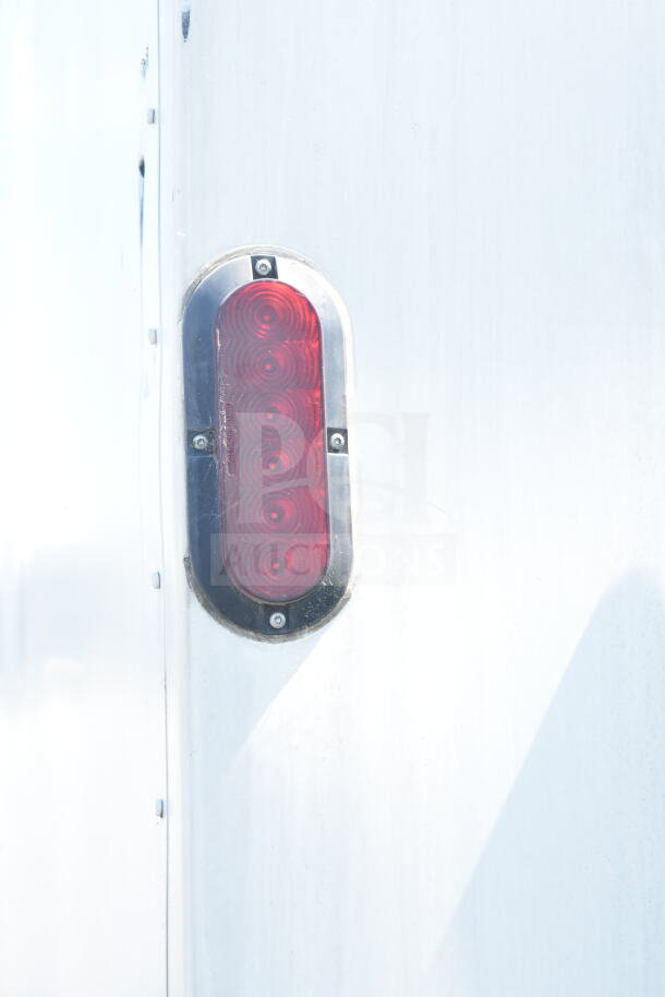 Red oval taillight on a 2021 Diamond Cargo 8.5'x24' food trailer, exterior detail.