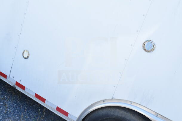 2021 Diamond Cargo 8.5'x24' food trailer, exterior view, white with red trim, equipped with CaptiveAire grease hood.