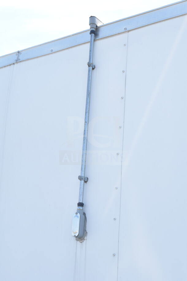 Exterior view of 2021 Diamond Cargo 8.5'x24' food trailer wall, with vent pipe installed.