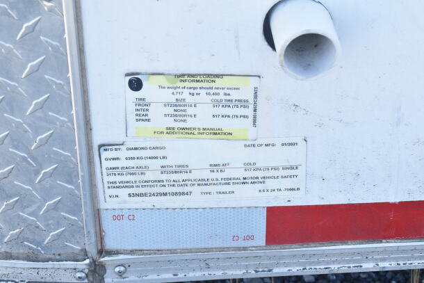 2021 Diamond Cargo 8.5'x24' food trailer label showing tire and loading info, GVWR 14,000 lbs, VIN 53NBE2429M1089847.