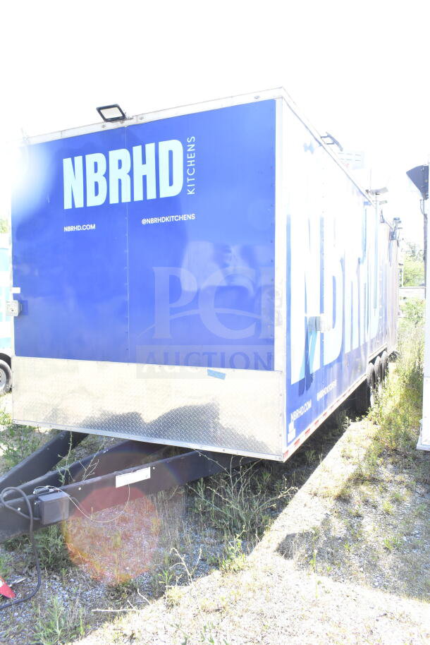 Rock Solid Cargo 8.5'x28' food trailer shell, blue exterior, CaptiveAire grease hood, labeled "NBRHD Kitchens."